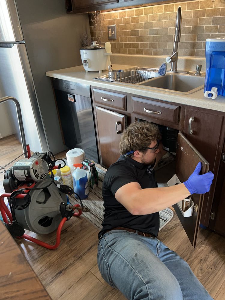Plumber clearing a kitchen drain