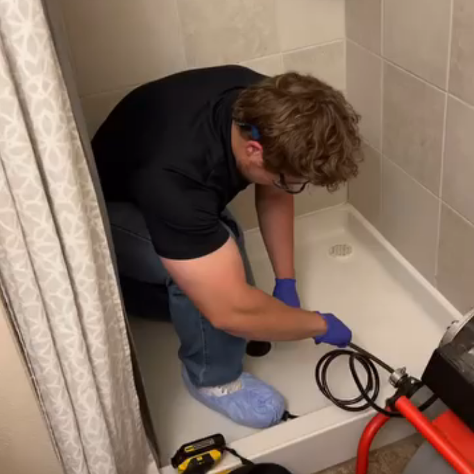 Marco Reyes of Great Bunny clearing a shower drain